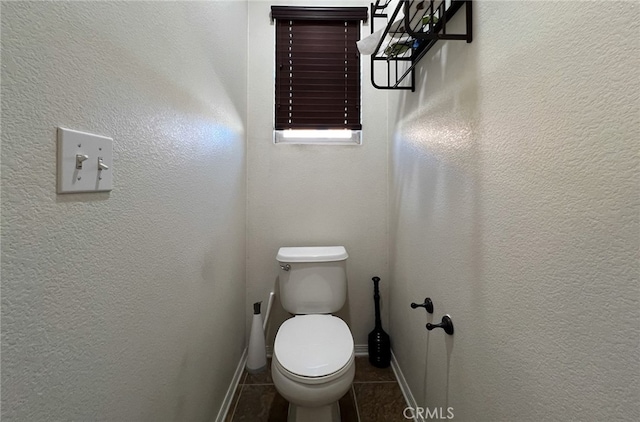 bathroom featuring tile patterned floors and toilet