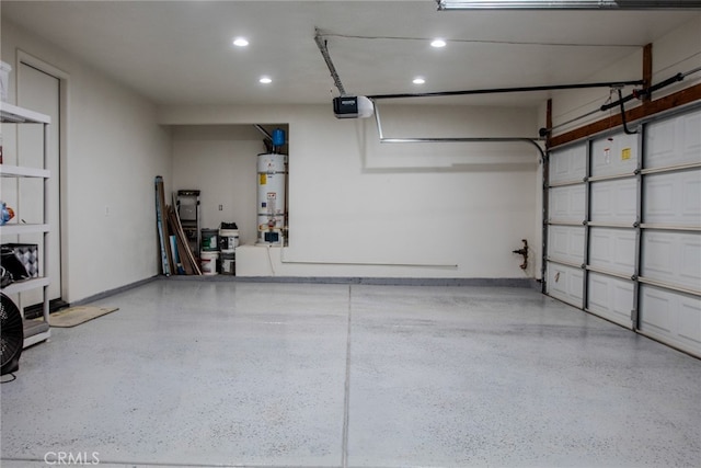 garage featuring a garage door opener and strapped water heater