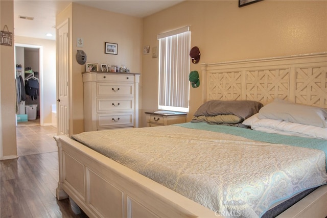 bedroom featuring a closet and dark hardwood / wood-style floors