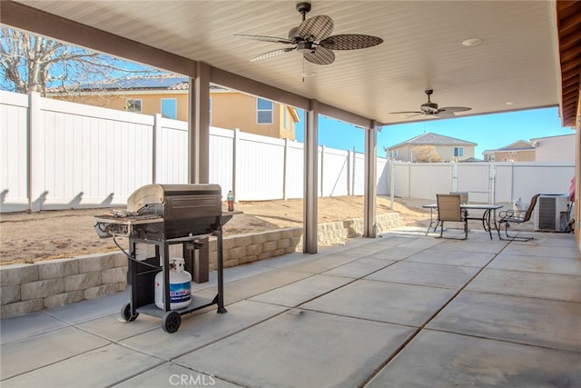 view of patio with area for grilling, central AC unit, and ceiling fan