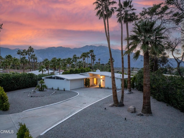 view of front of home with a garage and a mountain view