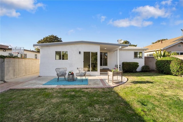 rear view of property with a patio and a yard