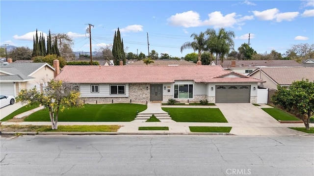 ranch-style home with a garage and a front lawn