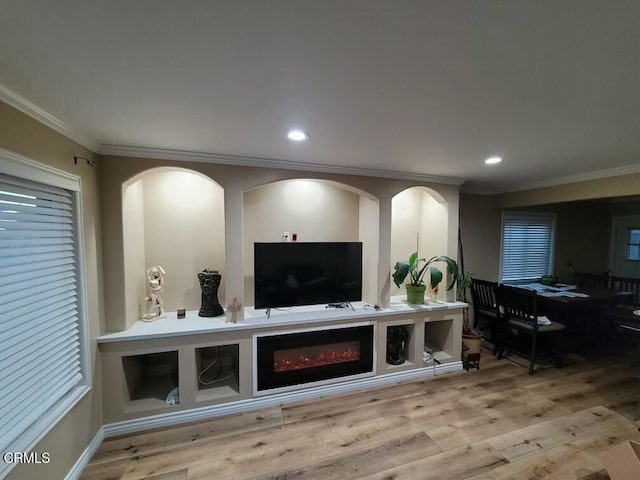 living room featuring crown molding and light wood-type flooring