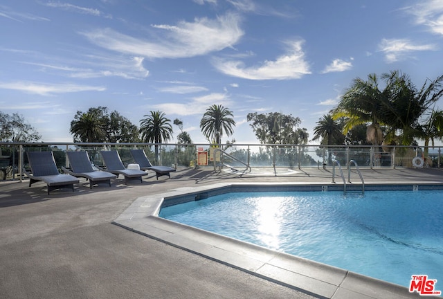 view of swimming pool with a patio area