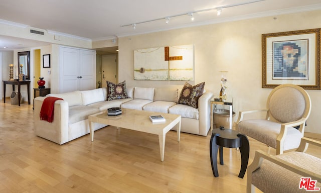 living room featuring ornamental molding and light hardwood / wood-style flooring