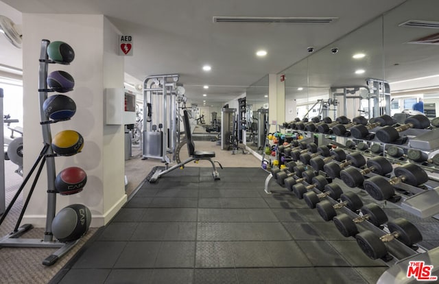 workout area with a wall mounted air conditioner