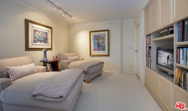 sitting room featuring light colored carpet, ornamental molding, rail lighting, and built in features