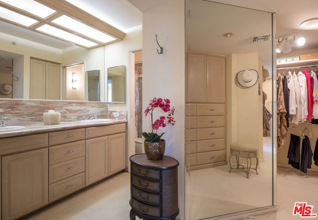 bathroom with tasteful backsplash and vanity