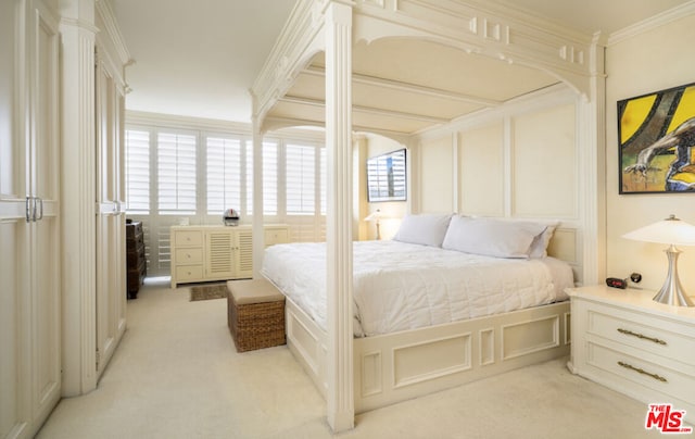 bedroom with crown molding and light colored carpet