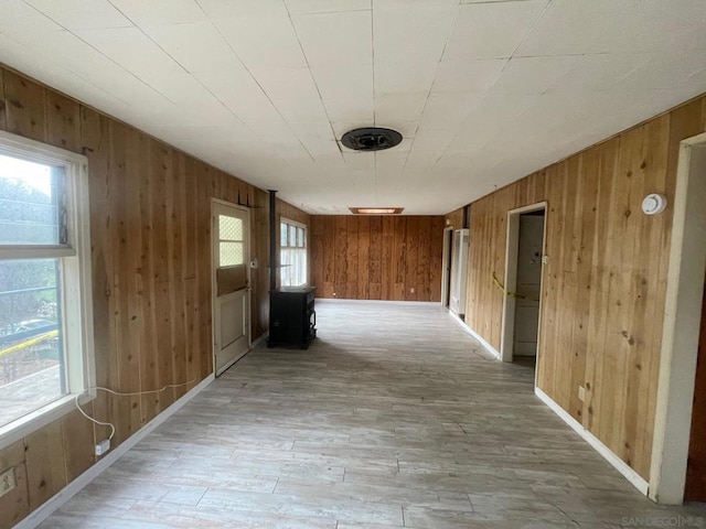 hallway featuring wood walls and light wood-type flooring