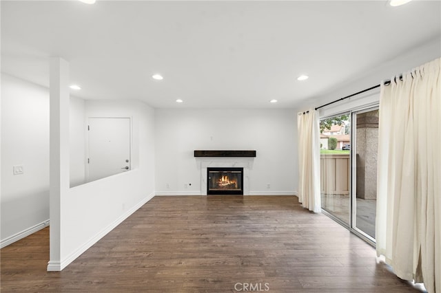 unfurnished living room with dark hardwood / wood-style flooring