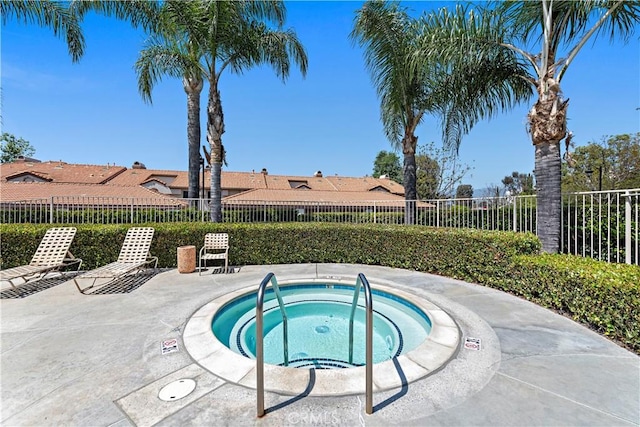 view of pool with a community hot tub and a patio area