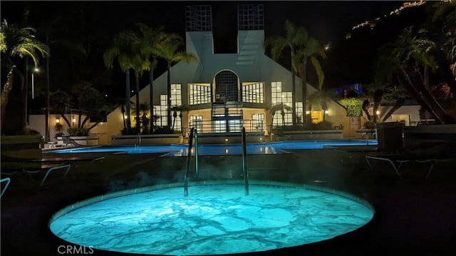 view of pool at night