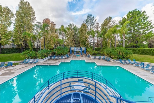 view of pool featuring a yard and a patio area