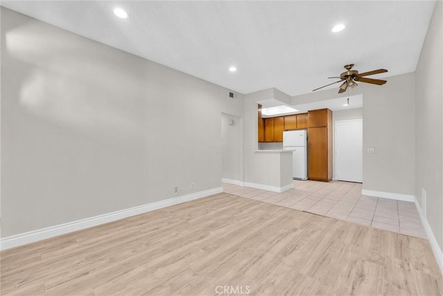 unfurnished living room with ceiling fan and light wood-type flooring