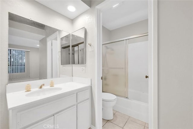 full bathroom featuring enclosed tub / shower combo, vanity, toilet, and tile patterned flooring