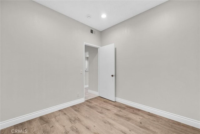 unfurnished room with light wood-type flooring