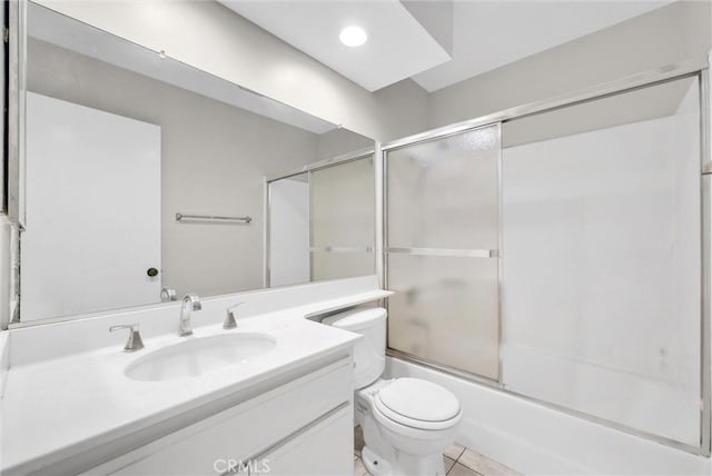 full bathroom featuring vanity, tile patterned flooring, toilet, and combined bath / shower with glass door