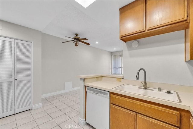 kitchen featuring sink, light tile patterned floors, dishwasher, kitchen peninsula, and ceiling fan