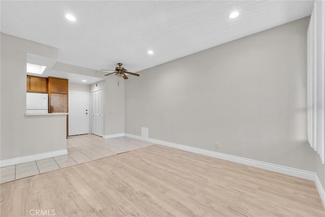 spare room with ceiling fan and light hardwood / wood-style flooring