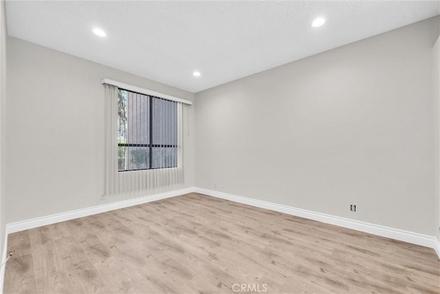 spare room featuring light hardwood / wood-style floors