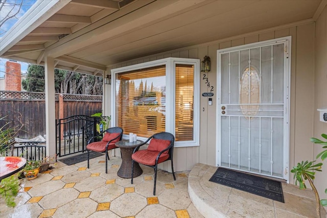 view of exterior entry featuring a patio area