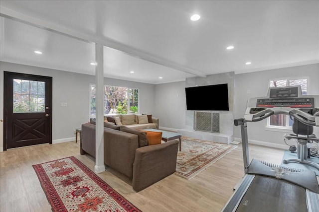 living room with beam ceiling and light hardwood / wood-style flooring