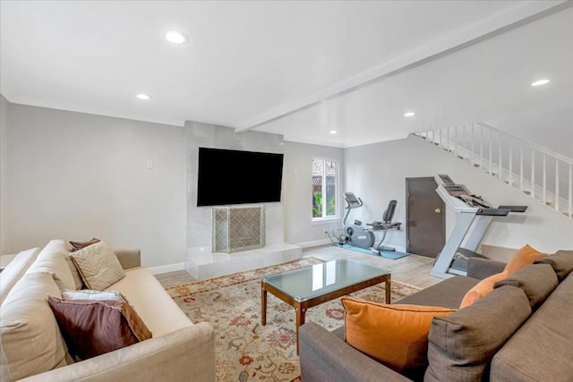 living room featuring beamed ceiling and light hardwood / wood-style flooring