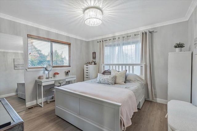 bedroom featuring ornamental molding and light hardwood / wood-style flooring