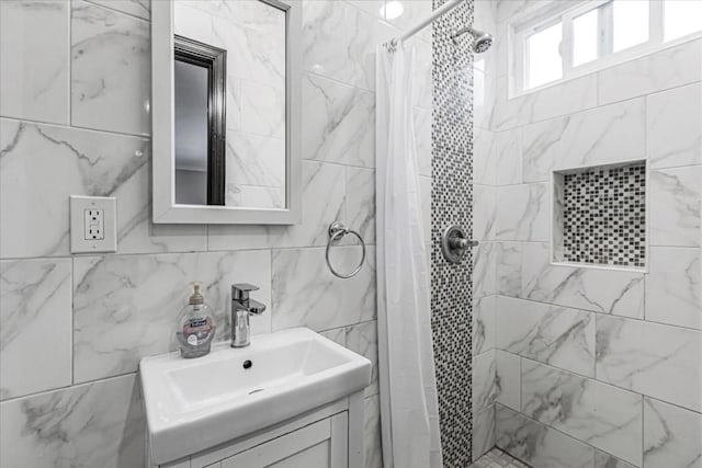 bathroom with vanity, curtained shower, and tile walls