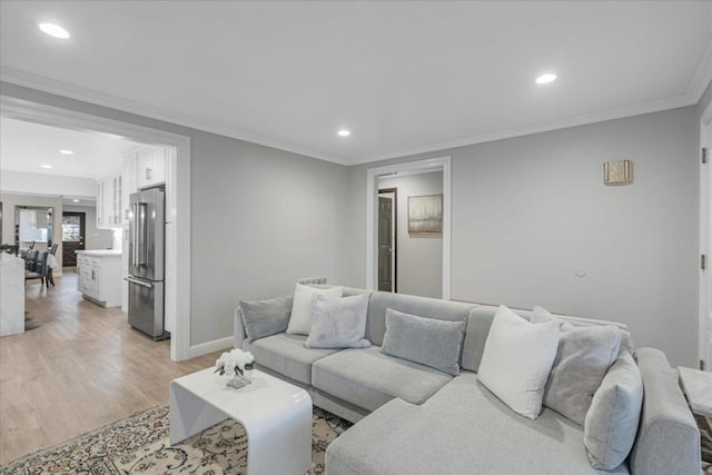 living room with crown molding and light hardwood / wood-style floors