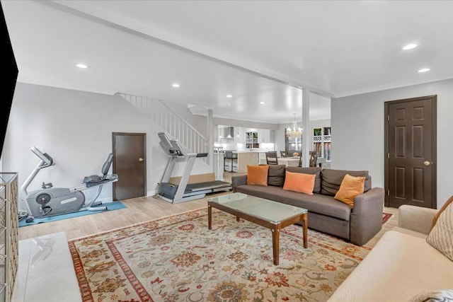 living room with a notable chandelier and light hardwood / wood-style flooring