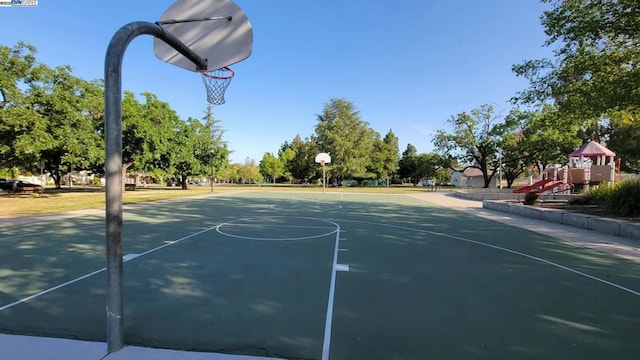 view of sport court featuring a playground