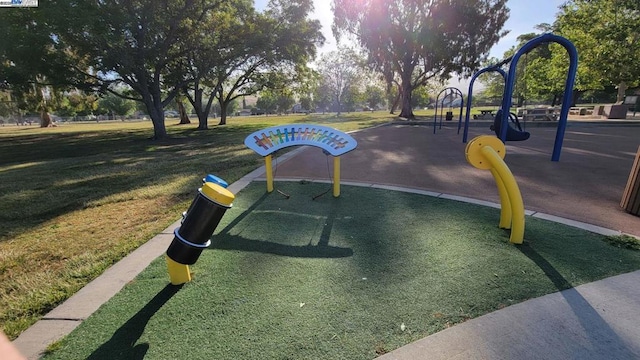 view of community featuring a playground and a lawn