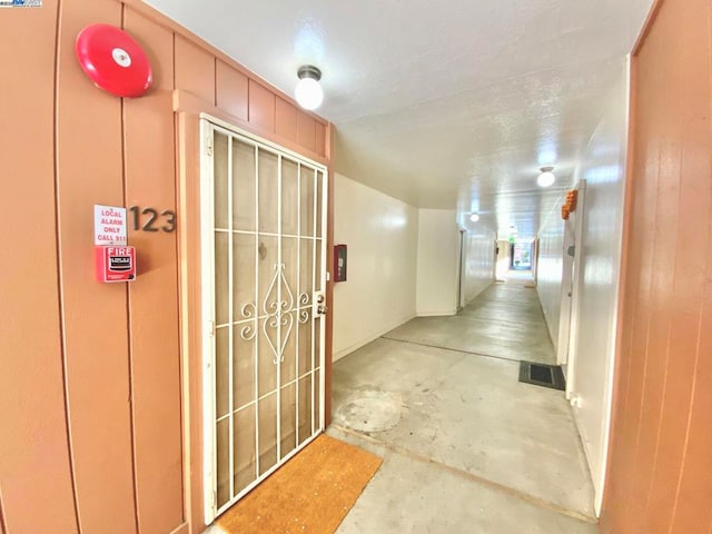 hall featuring concrete floors