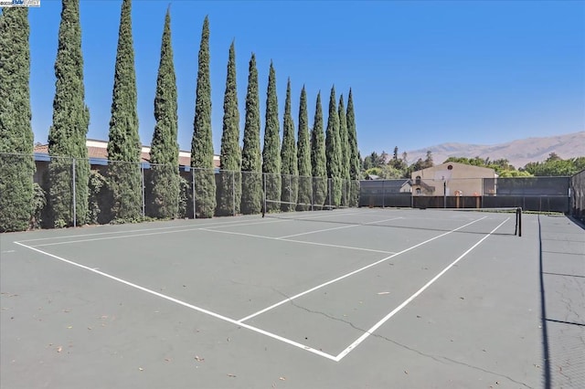 view of tennis court with a mountain view