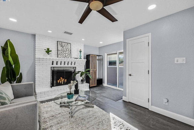 living room featuring a brick fireplace and ceiling fan