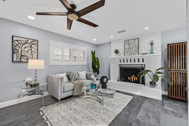 living room with ceiling fan and a brick fireplace