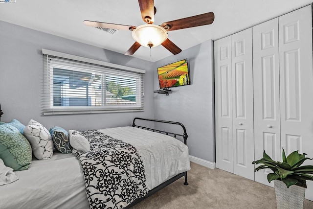 carpeted bedroom with a closet and ceiling fan