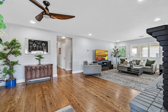 living room with hardwood / wood-style flooring and ceiling fan