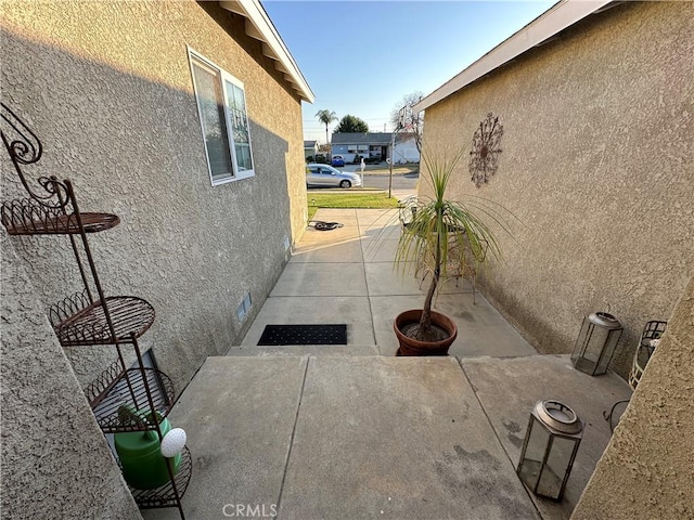 view of side of property with a patio