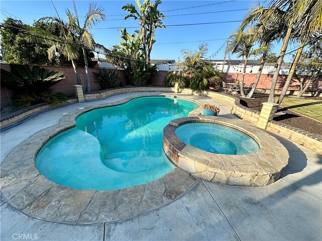 view of pool with an in ground hot tub