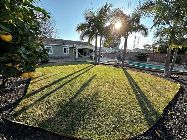 view of yard with a fenced in pool and a patio area