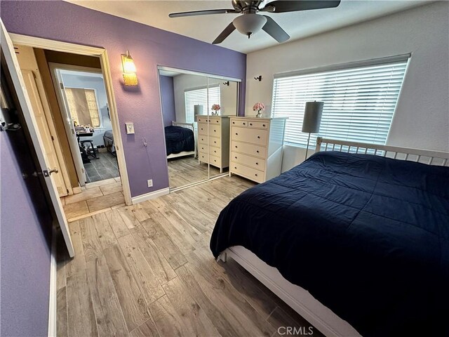 bedroom with hardwood / wood-style flooring, ceiling fan, and a closet