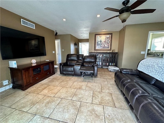 tiled living room featuring ceiling fan