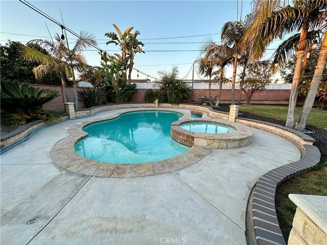 view of swimming pool featuring an in ground hot tub