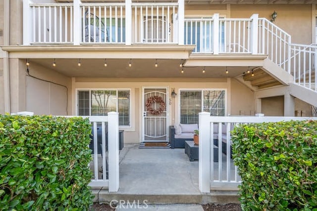 view of exterior entry with a balcony