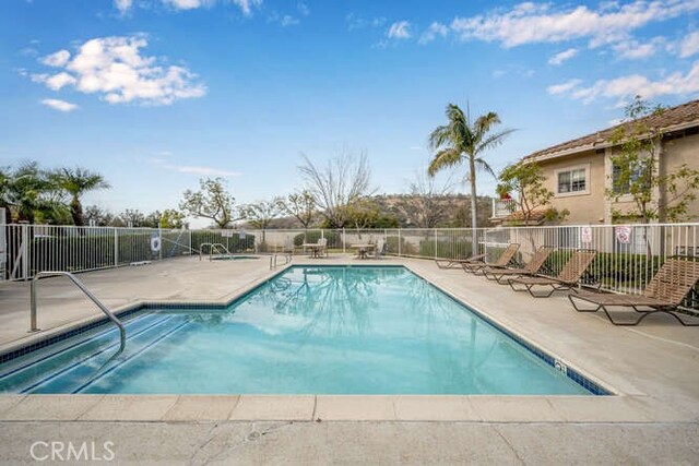 view of swimming pool with a patio