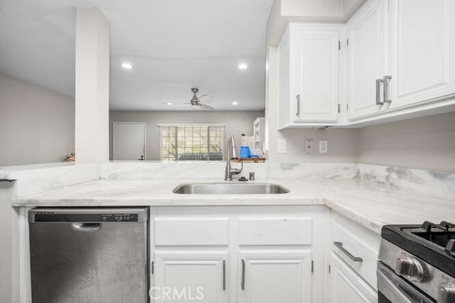 kitchen featuring a peninsula, white cabinetry, stainless steel appliances, and a sink